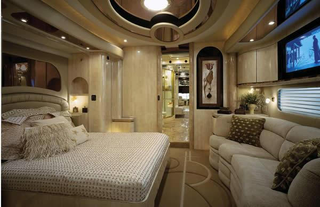 Illustration for article titled Luxury Caravan Has Sports Car Parking Dock In Its Belly